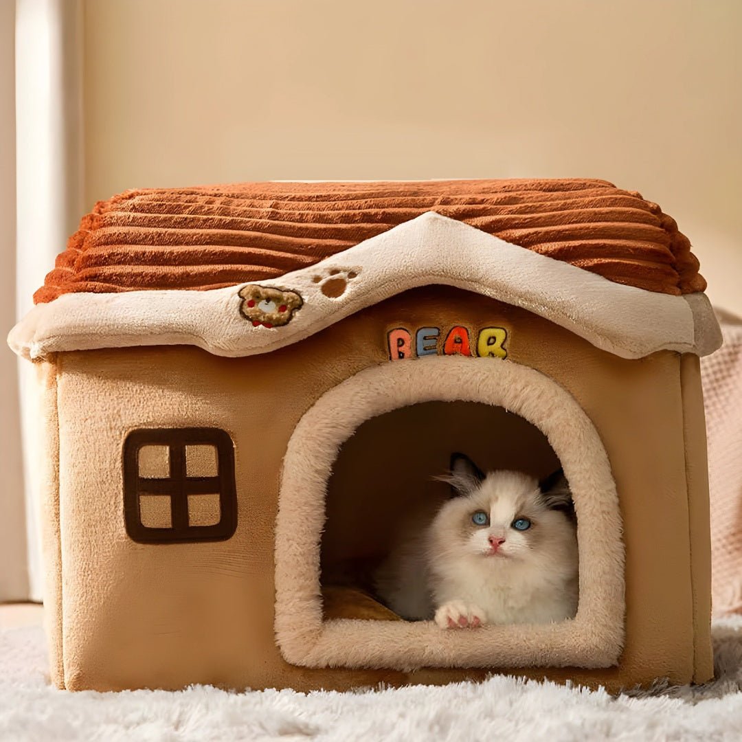 Fluffy cat with blue eyes resting inside a plush house labeled BEAR, designed by European House Hold for cozy indoor pet comfort