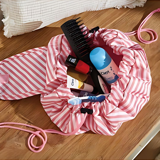 Pink striped TOPMOVE German-made foldable makeup bag with drawstring.