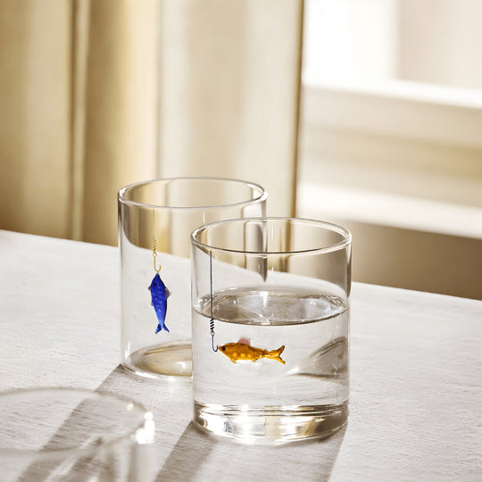 Hand-blown 400ml drinking glass with suspended fish-on-hook design, available in blue or orange – perfect for Beirut homes.