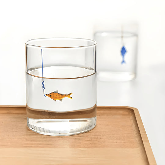 Hand-blown 400ml drinking glass with suspended fish-on-hook design, available in blue or orange – perfect for Beirut homes.