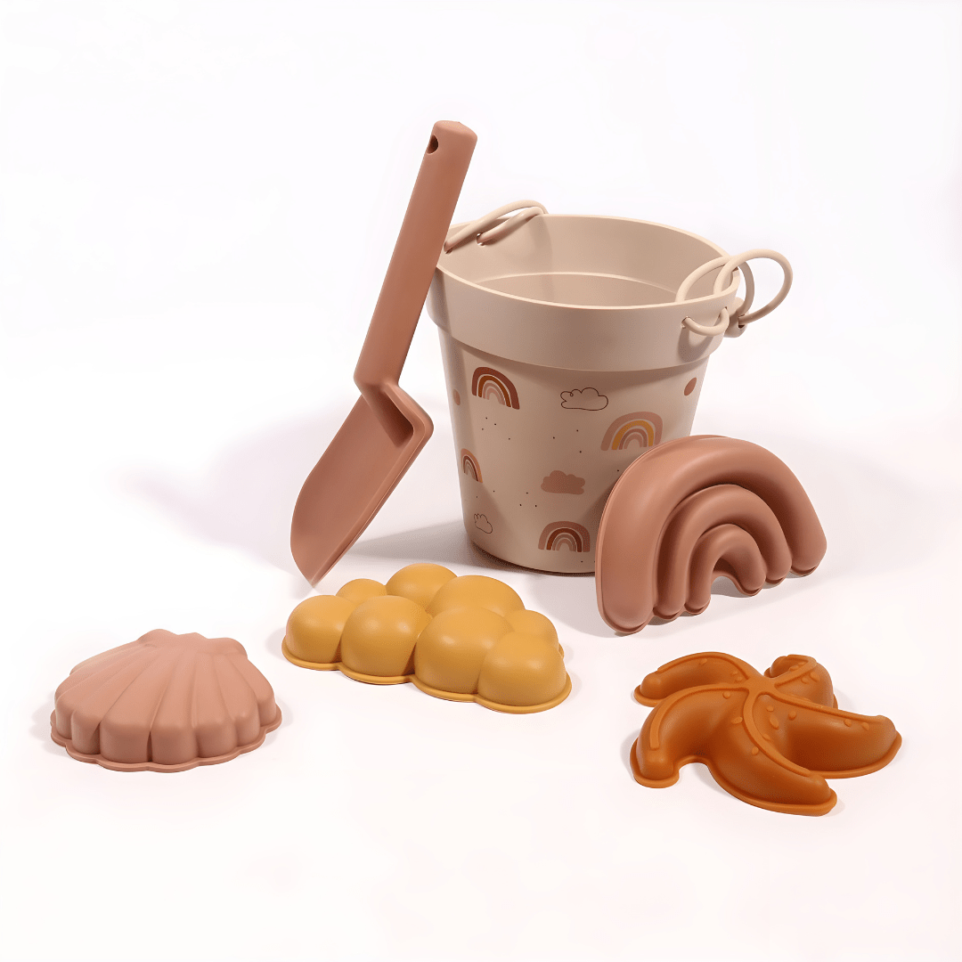 Silicone beach bucket set with shovel and sand molds for kids – BPA-free and safe, photographed on a sunny beach in Beirut, Lebanon