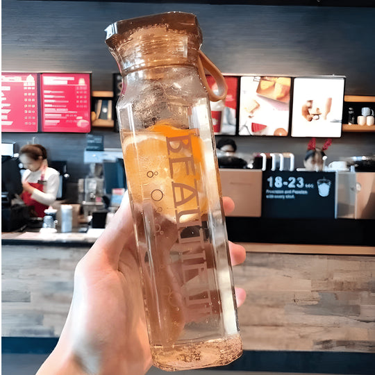 Diamond-shaped glass water bottle with fruit infusion, 500ml, available in amber, aqua, and ruby pink – eco-friendly with strap.