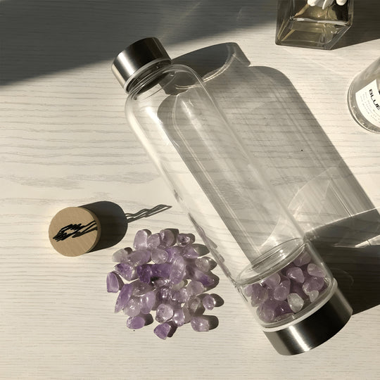 Crystal elixir glass water bottle with stainless steel lid and black protective neoprene case – 550ml