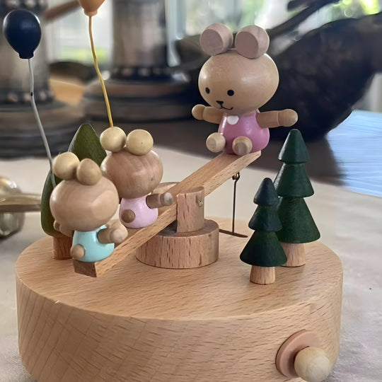 Wooden bunny family music box playing melody with moving seesaw