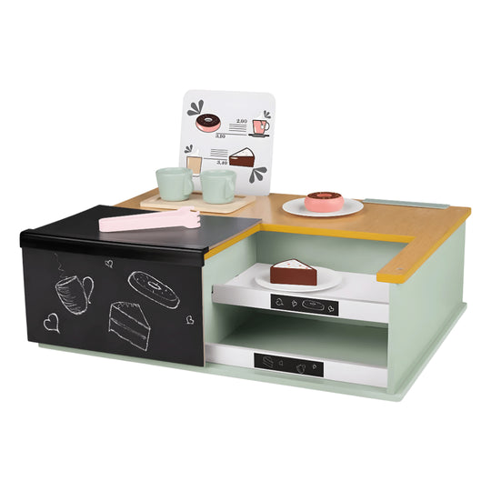 Angled view of a wooden toy café setup featuring toy cups, cakes, and espresso machine