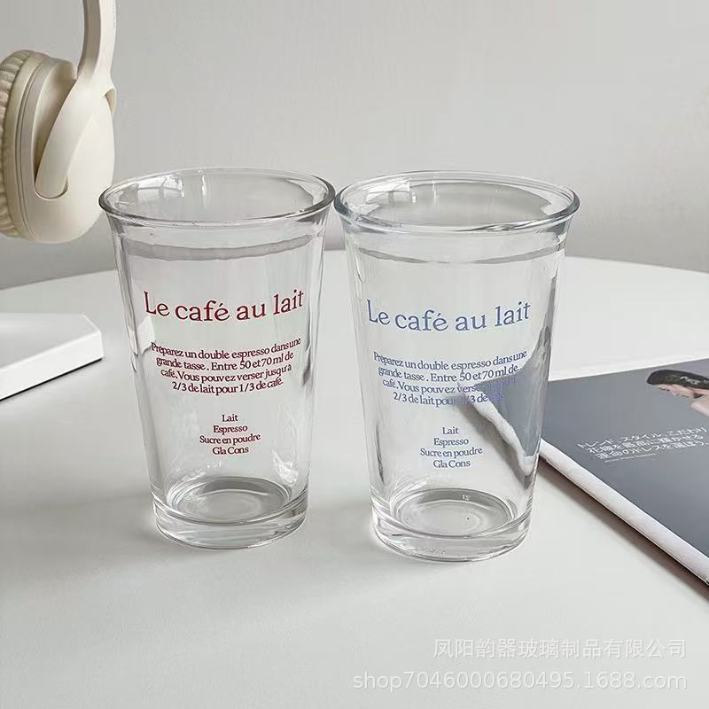 Korean-style 350ml clear glass tumbler with red or blue “Le café au lait” lettering, suitable for hot and cold drinks