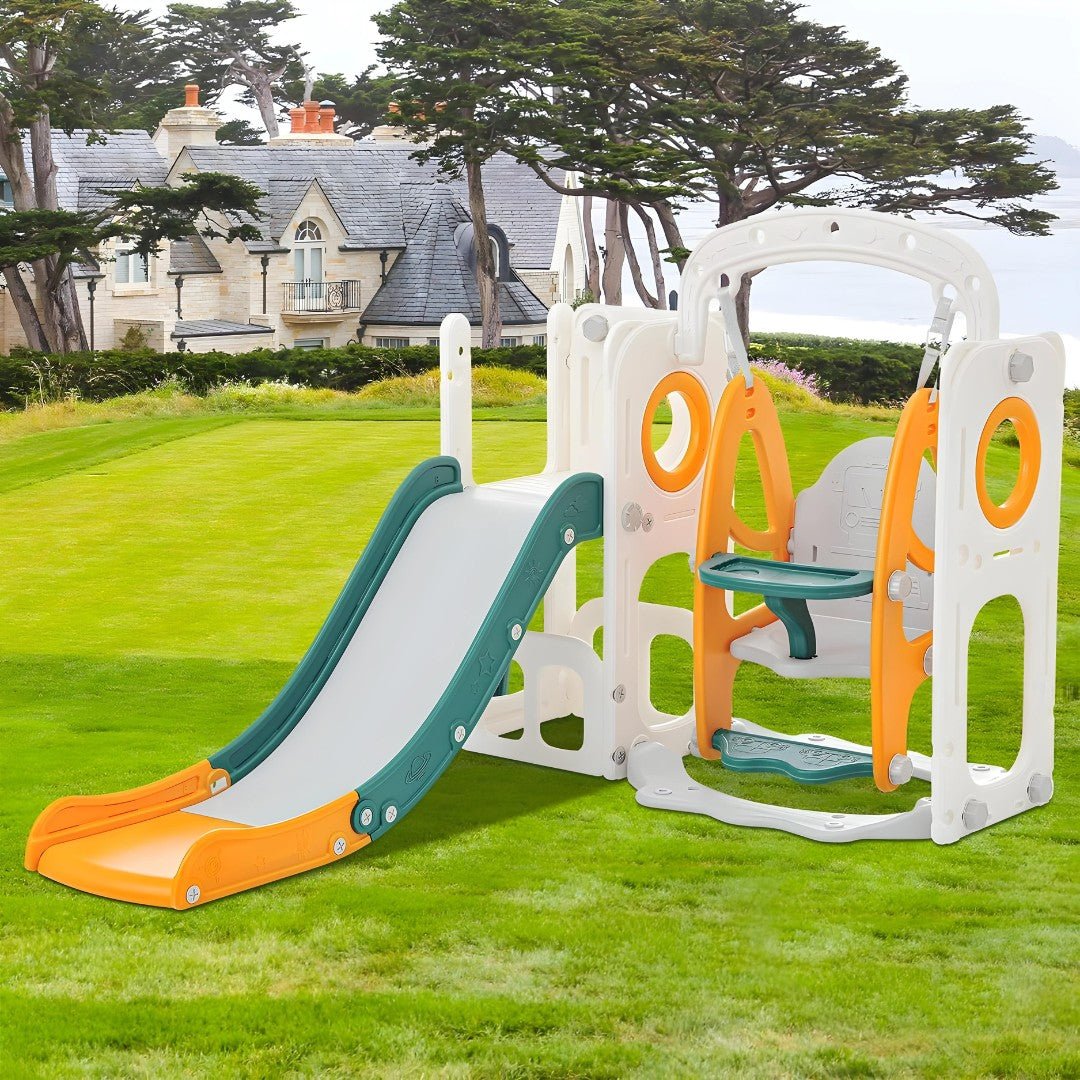 Colorful kids outdoor playset with slide and swing set up on green grass with a scenic background