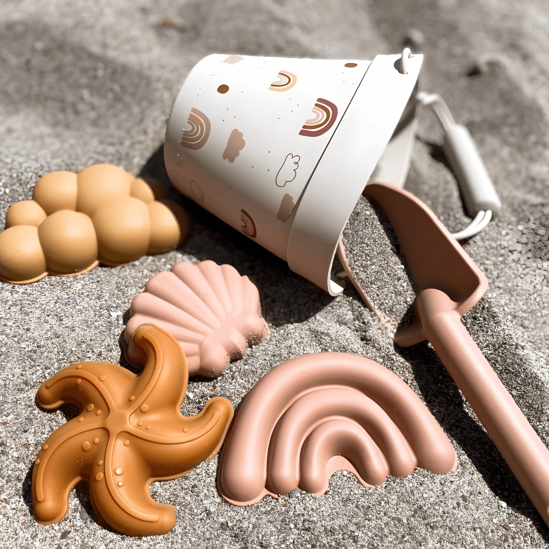 Silicone beach bucket set with shovel and sand molds for kids – BPA-free and safe, photographed on a sunny beach in Beirut, Lebanon