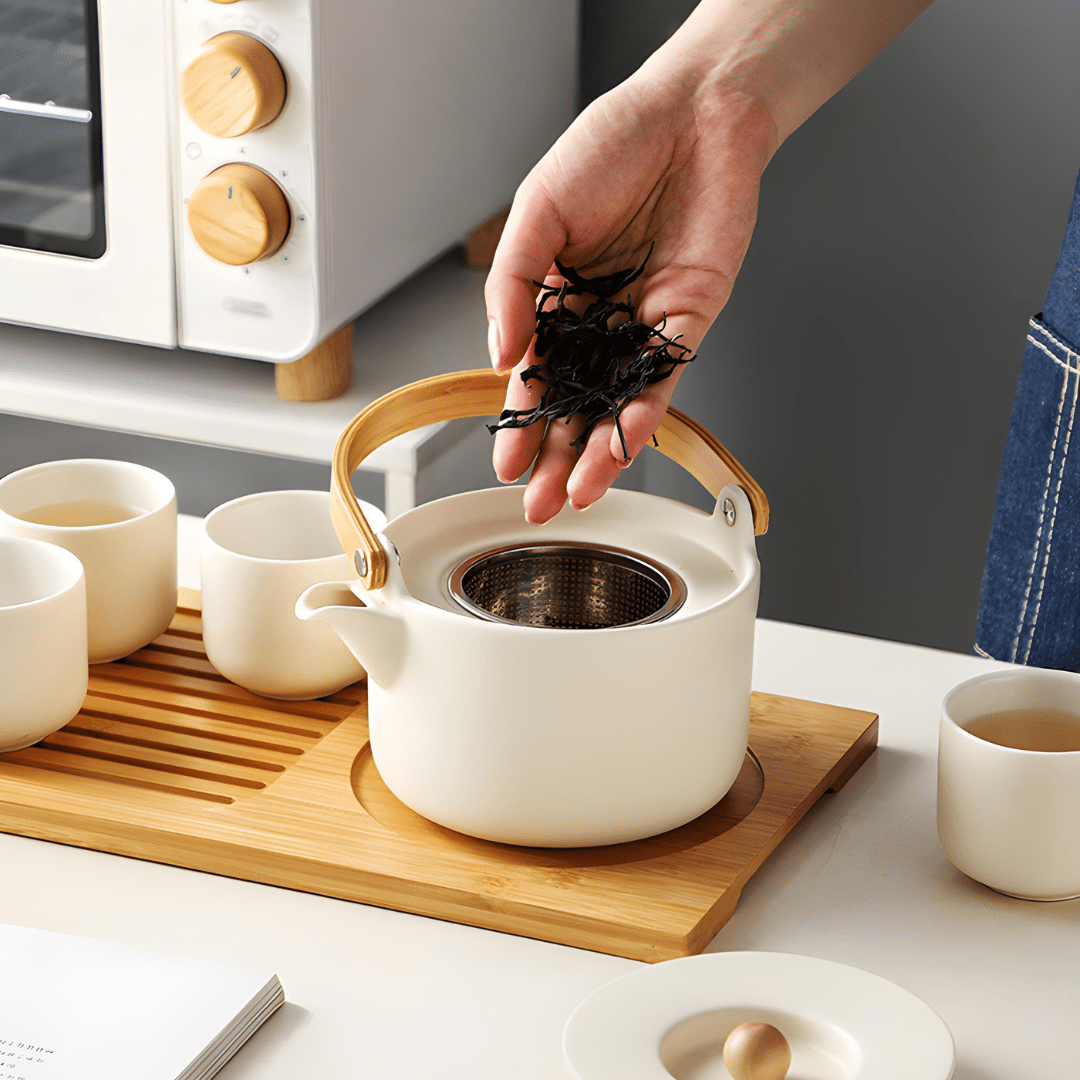 Handmade ceramic tea set with 650ml teapot, four 110ml cups, and bamboo serving tray – artisan glaze, eco-friendly, and gift-ready.

