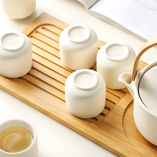 Handmade ceramic tea set with 650ml teapot, four 110ml cups, and bamboo serving tray – artisan glaze, eco-friendly, and gift-ready.

