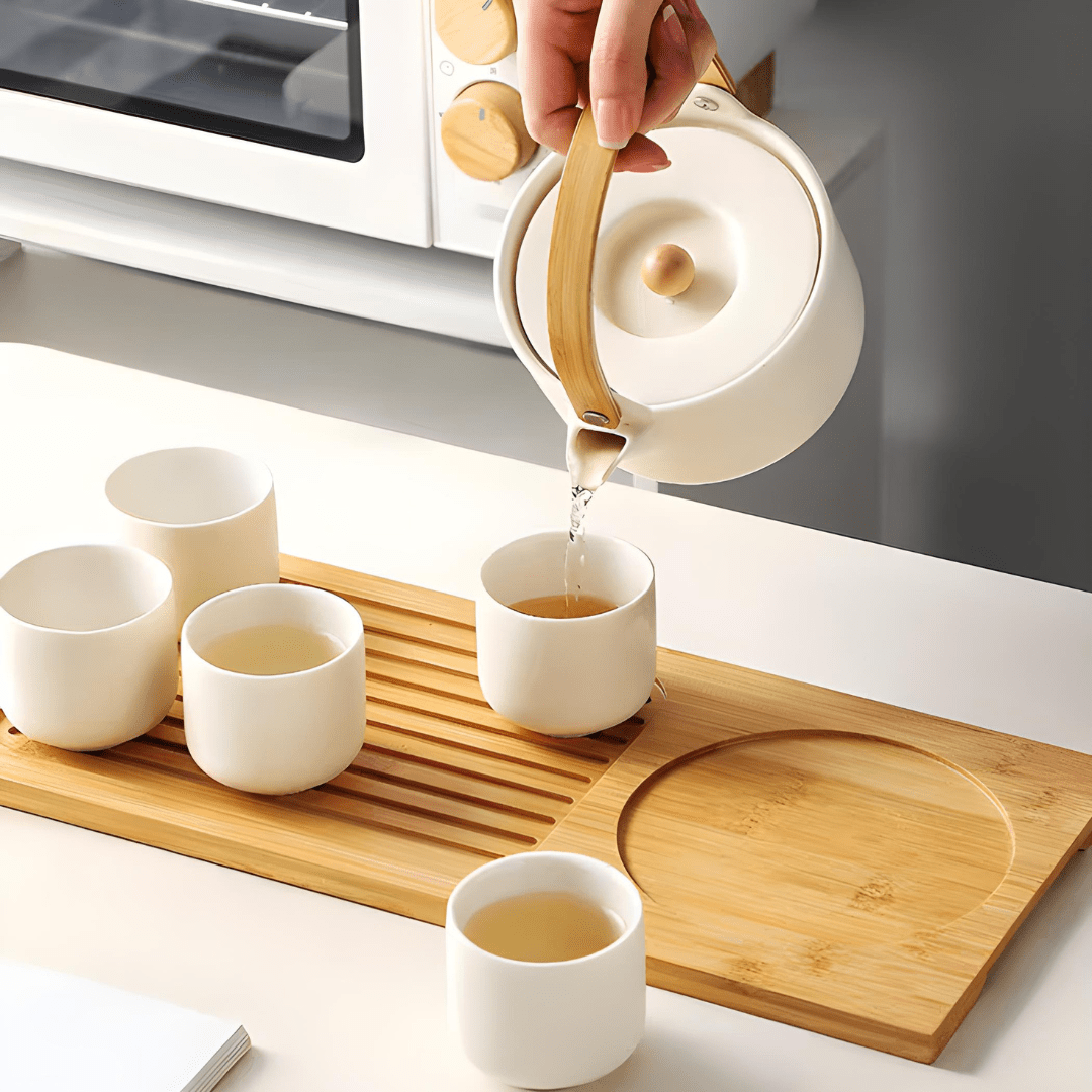 Handmade ceramic tea set with 650ml teapot, four 110ml cups, and bamboo serving tray – artisan glaze, eco-friendly, and gift-ready.

