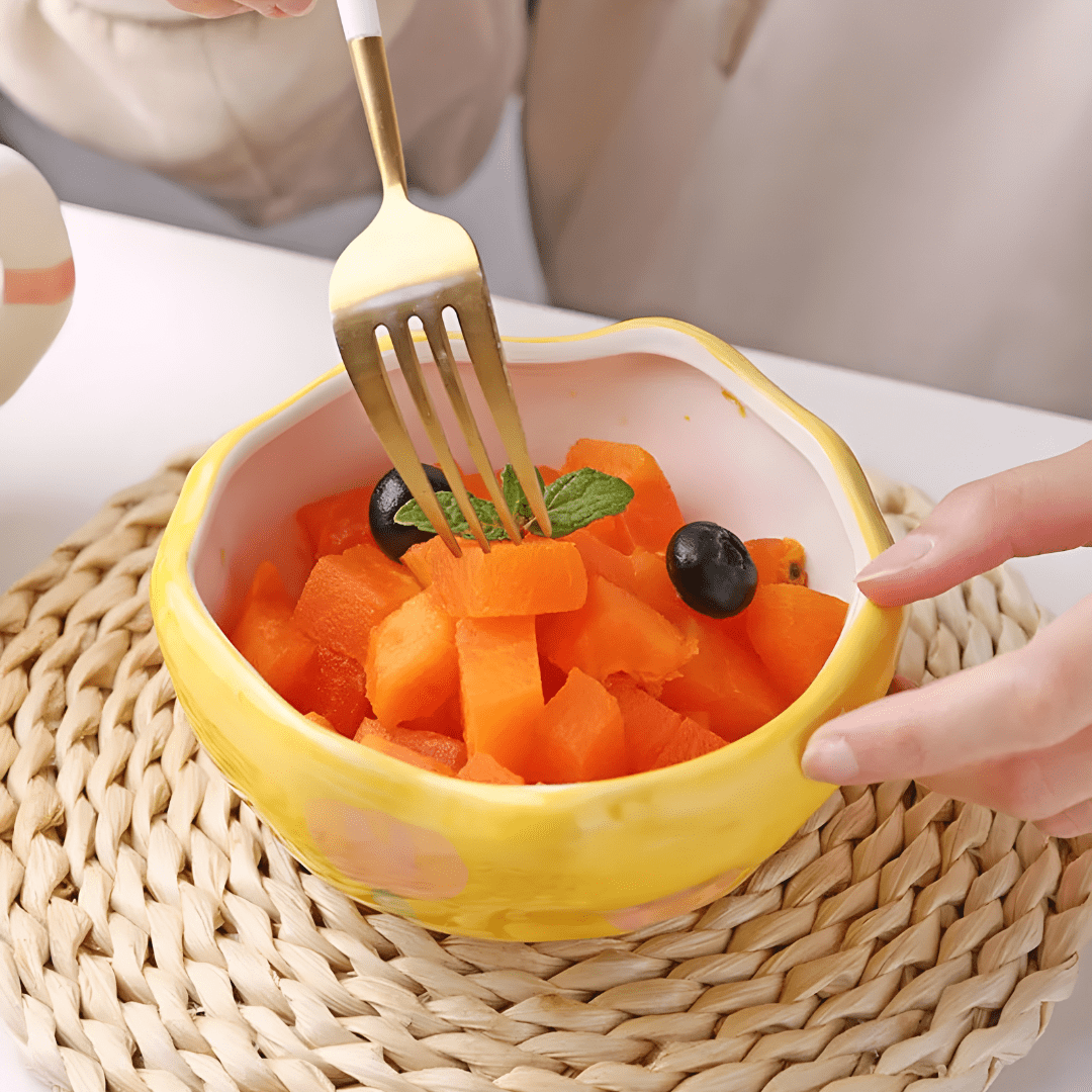 450ml yellow hand-pinched ceramic bowl filled with papaya, blueberries, and mint leaves.