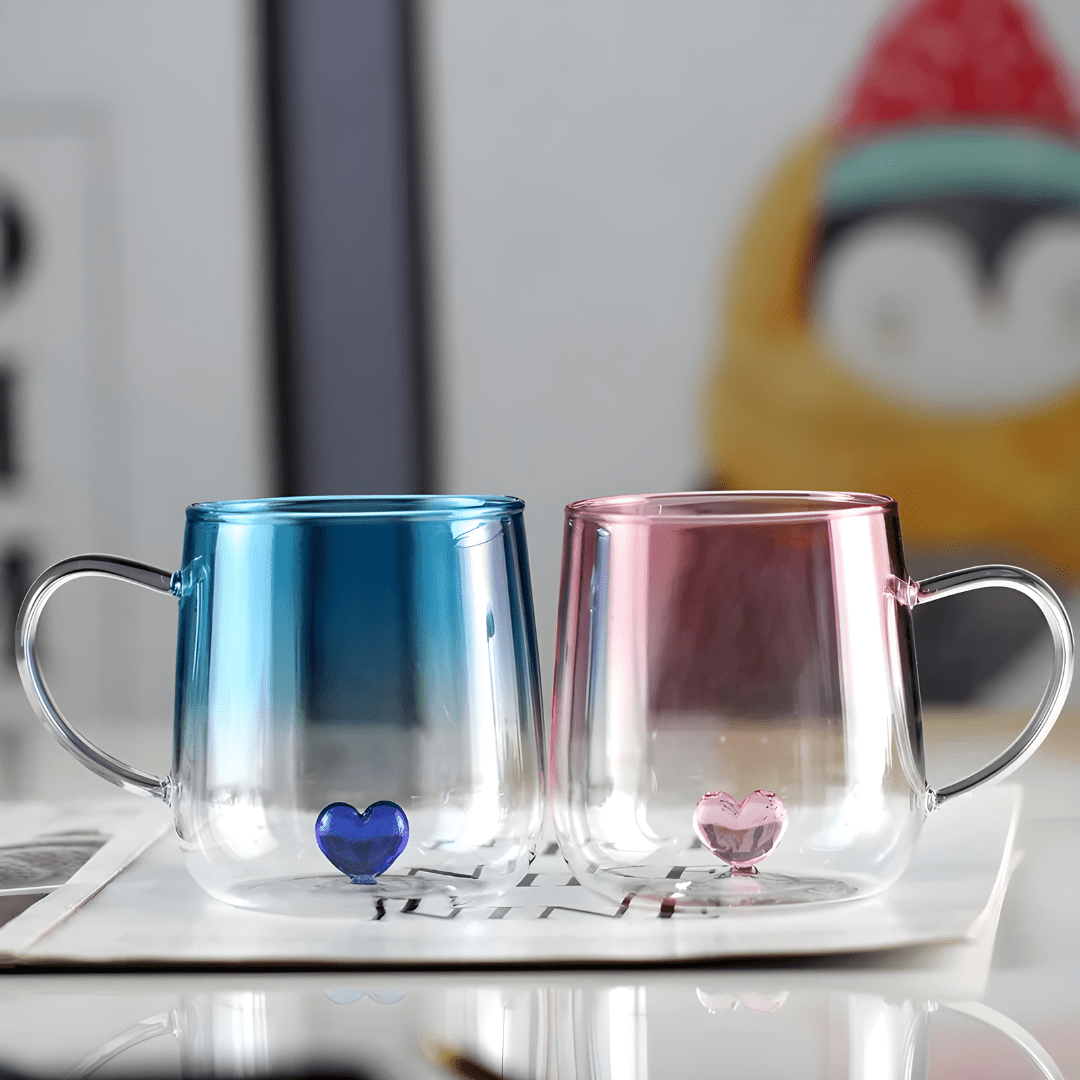 Transparent borosilicate glass cups with pink and blue heart designs, featuring gradient color and elegant handles – 400ml capacity.