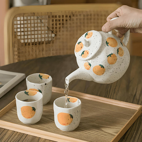 Porcelain citrus tea set with 850ml teapot and four 150ml cups – hand-painted orange pattern, perfect for summer tea moments in Beirut