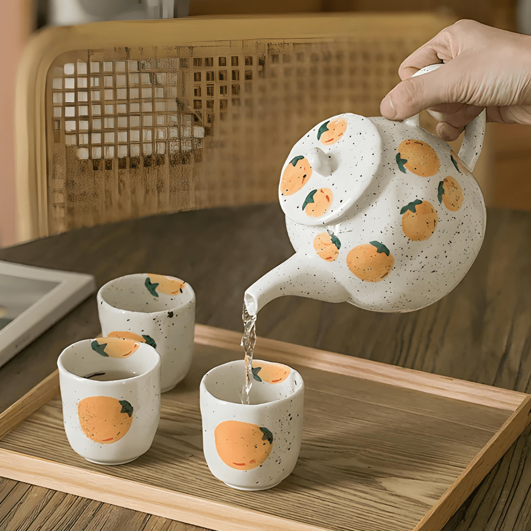 Porcelain citrus tea set with 850ml teapot and four 150ml cups – hand-painted orange pattern, perfect for summer tea moments in Beirut