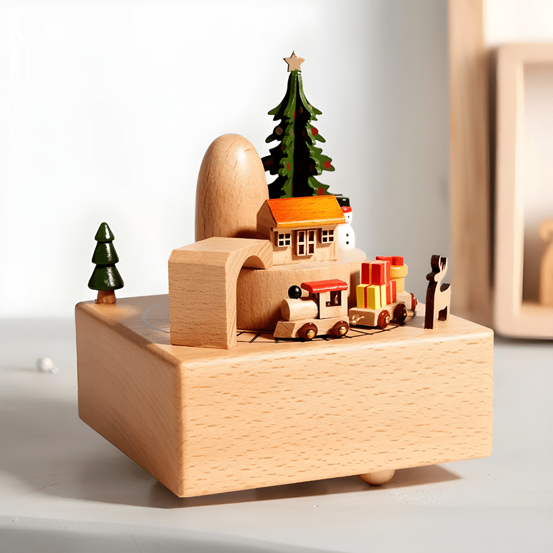 Handcrafted wooden Christmas music box with a rotating miniature train and snowy holiday scene.