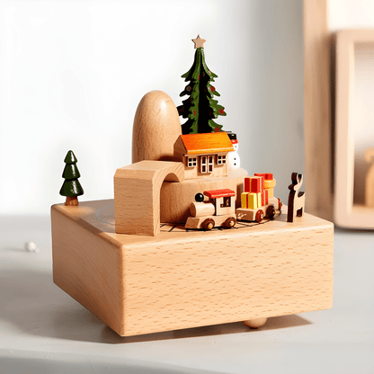 Handcrafted wooden Christmas music box with a rotating miniature train and snowy holiday scene.