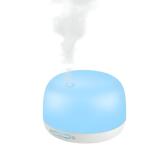 Silvercrest white ultrasonic aroma diffuser on a wooden table with cool mist rising, rechargeable Type-C aromatherapy device.
