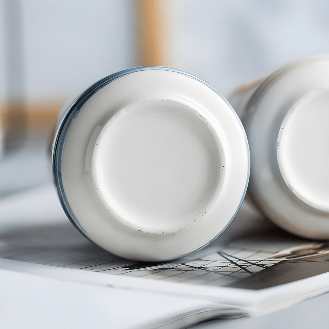 Matte white Nordic ceramic shampoo dispenser 430ml with silver pump on a modern bathroom shelf.