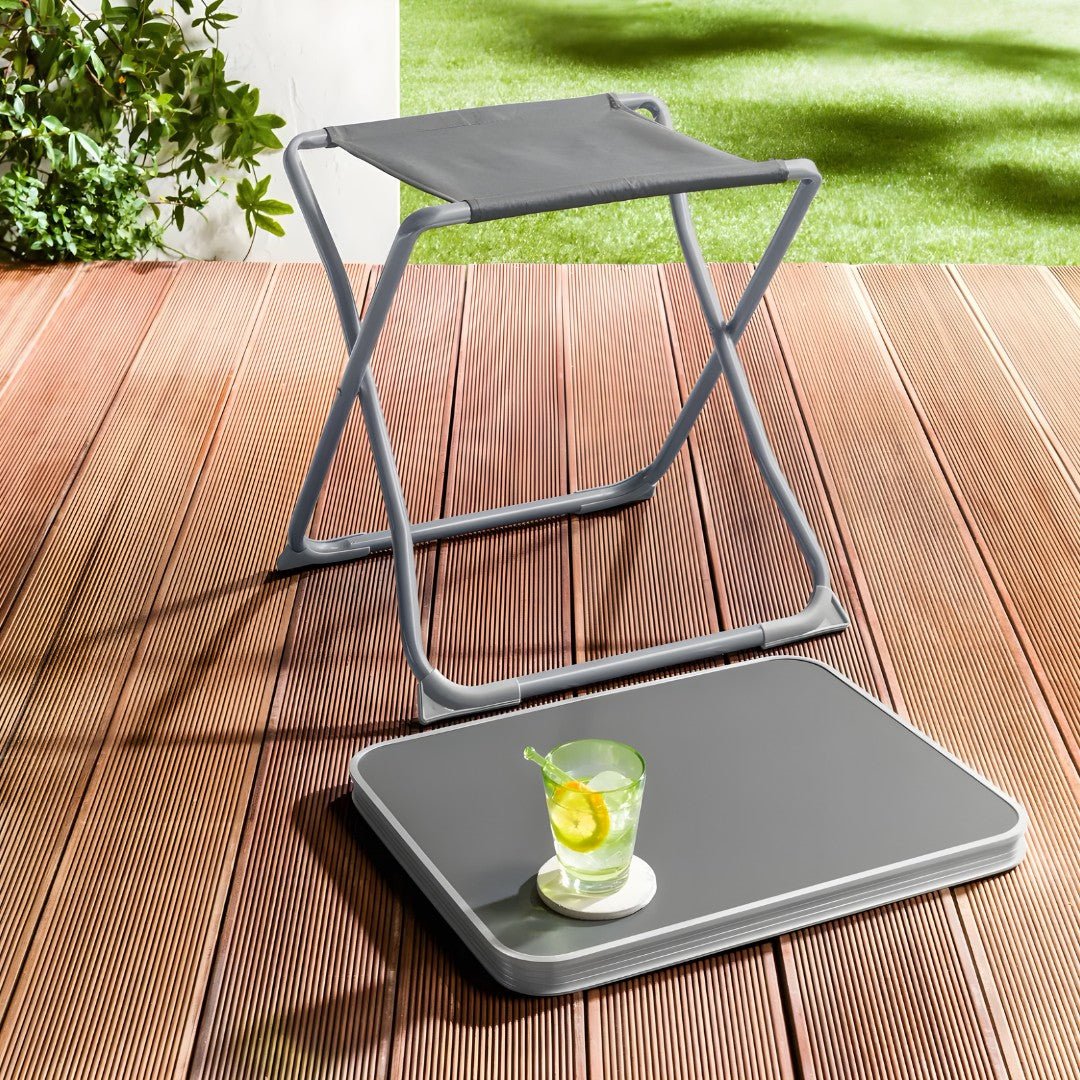foldable outdoor stool and portable table on a wooden deck with a refreshing drink on top