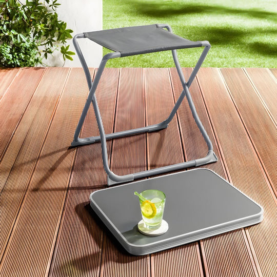 foldable outdoor stool and portable table on a wooden deck with a refreshing drink on top