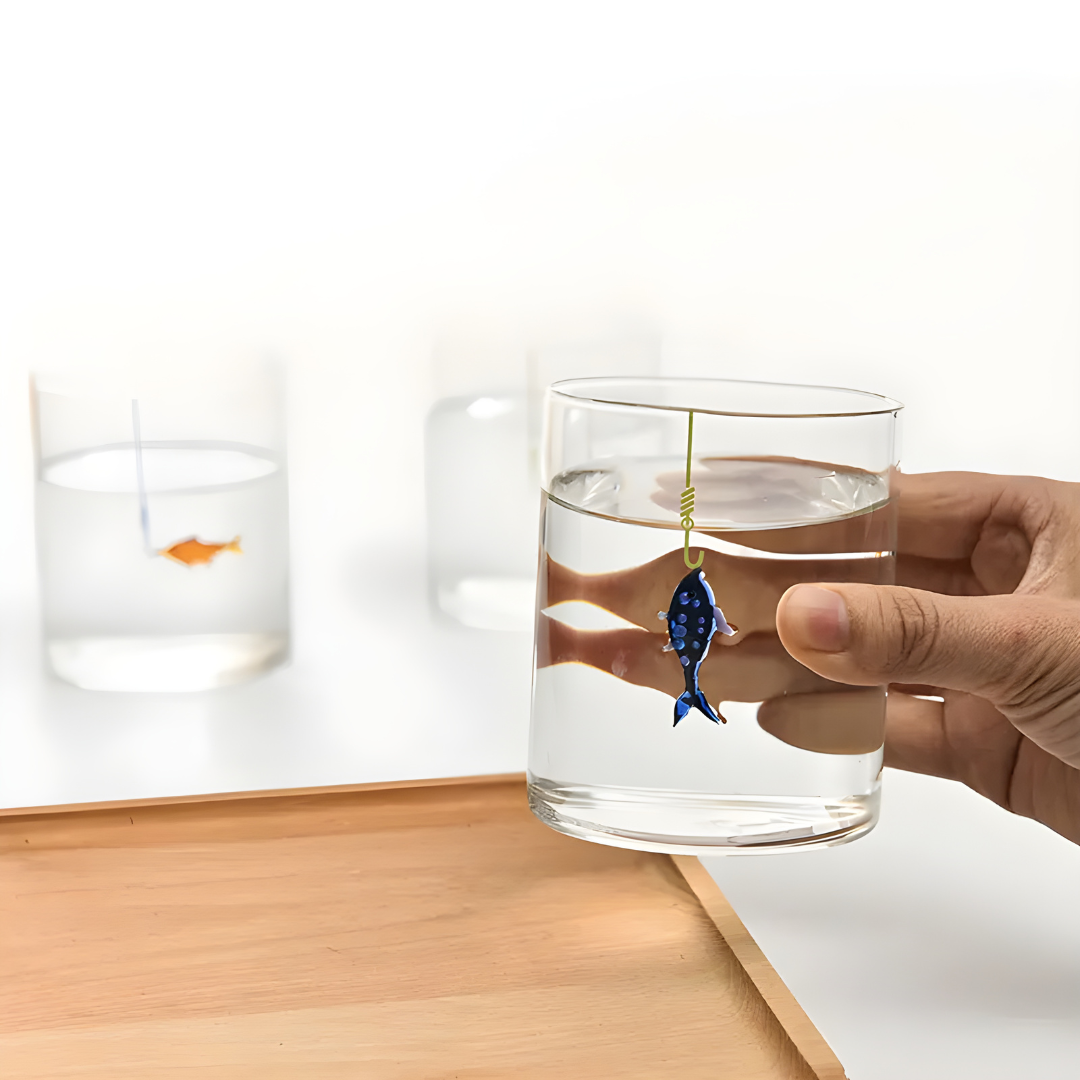 Hand-blown 400ml drinking glass with suspended fish-on-hook design, available in blue or orange – perfect for Beirut homes.