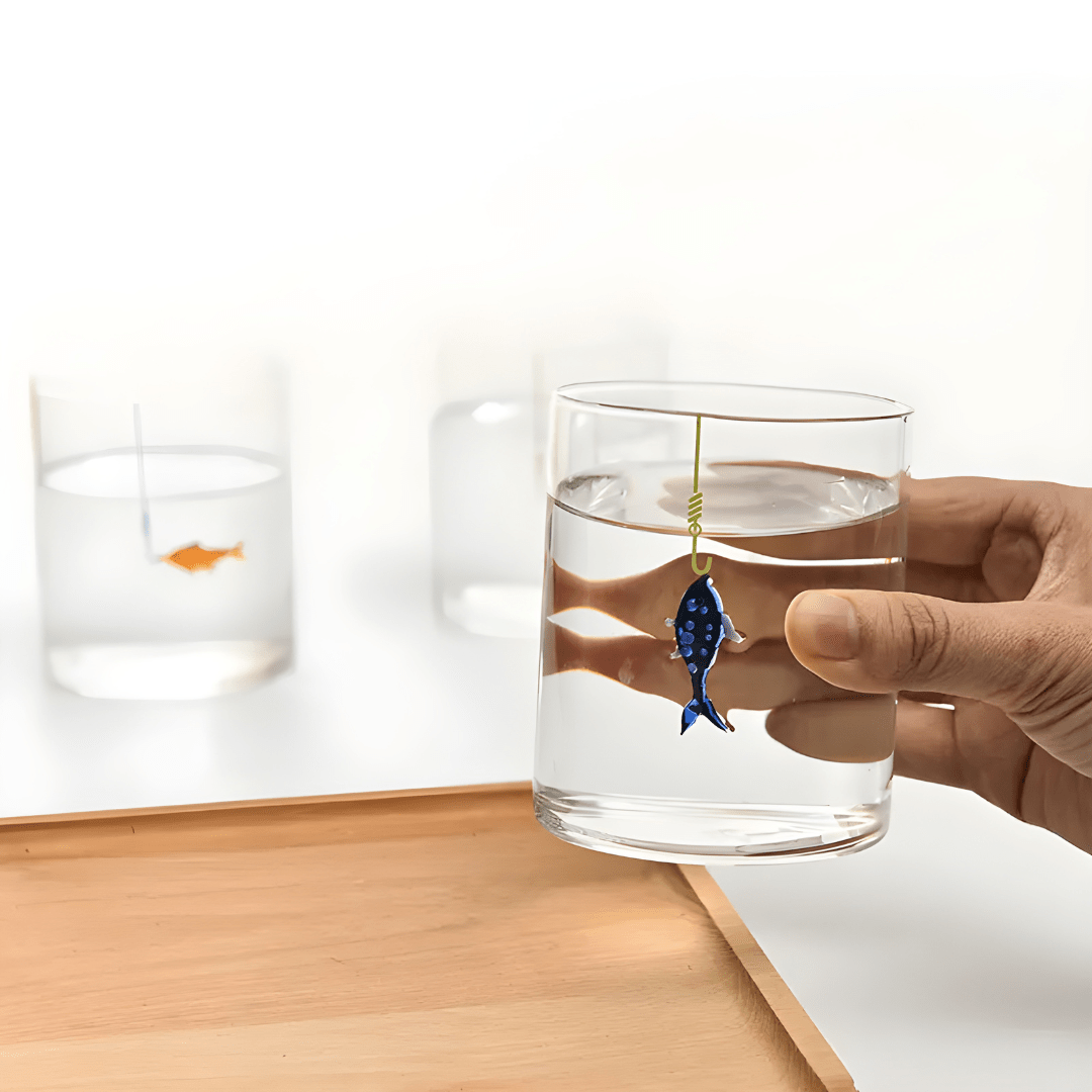 Hand-blown 400ml drinking glass with suspended fish-on-hook design, available in blue or orange – perfect for Beirut homes.