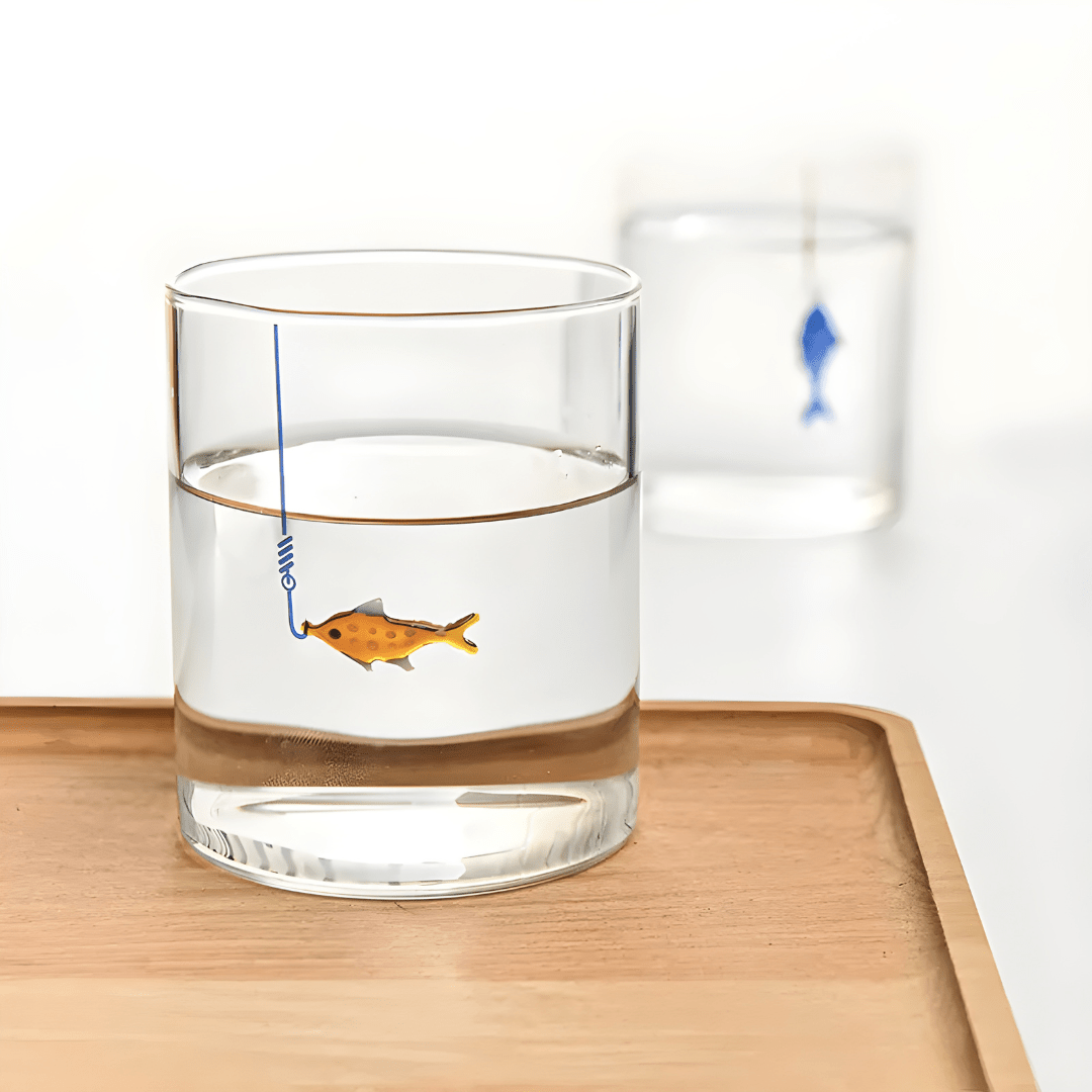 Hand-blown 400ml drinking glass with suspended fish-on-hook design, available in blue or orange – perfect for Beirut homes.