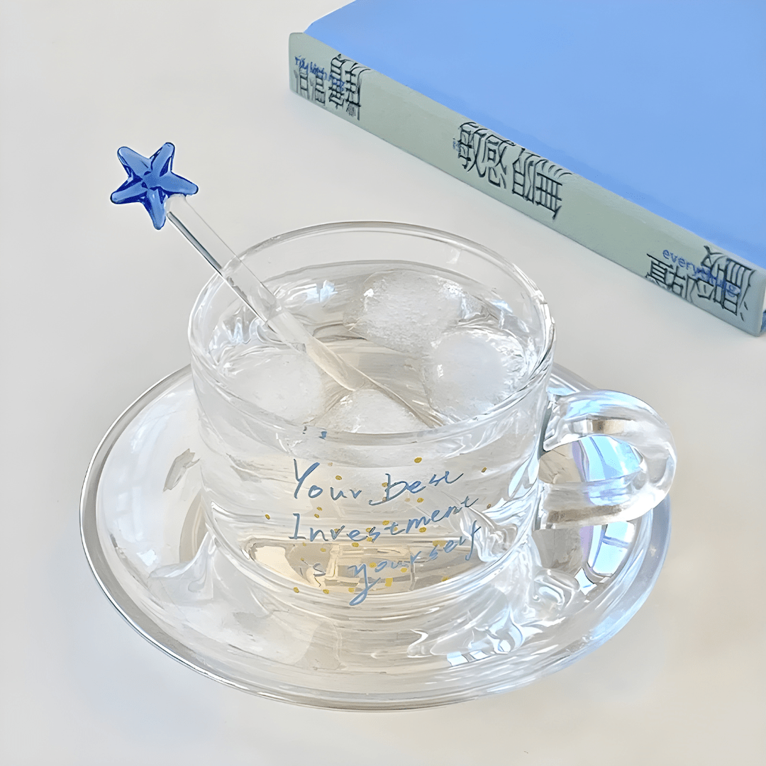 Clear 200ml glass cups with saucers and stirrers, each with a motivational quote and unique stirrer design – perfect for hot or cold beverages in Beirut.

