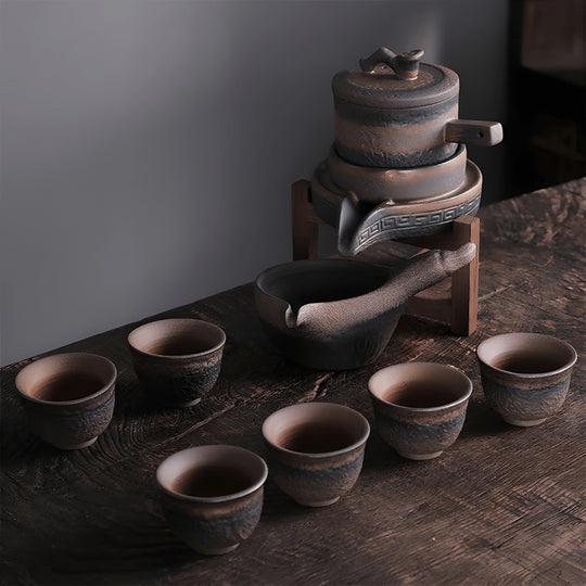 Handcrafted ceramic stoneware teapot set with cups and wooden base for traditional tea brewing