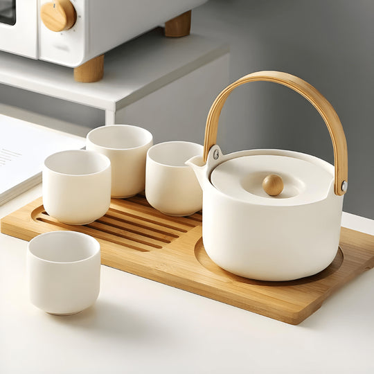 Handmade ceramic tea set with 650ml teapot, four 110ml cups, and bamboo serving tray – artisan glaze, eco-friendly, and gift-ready.


