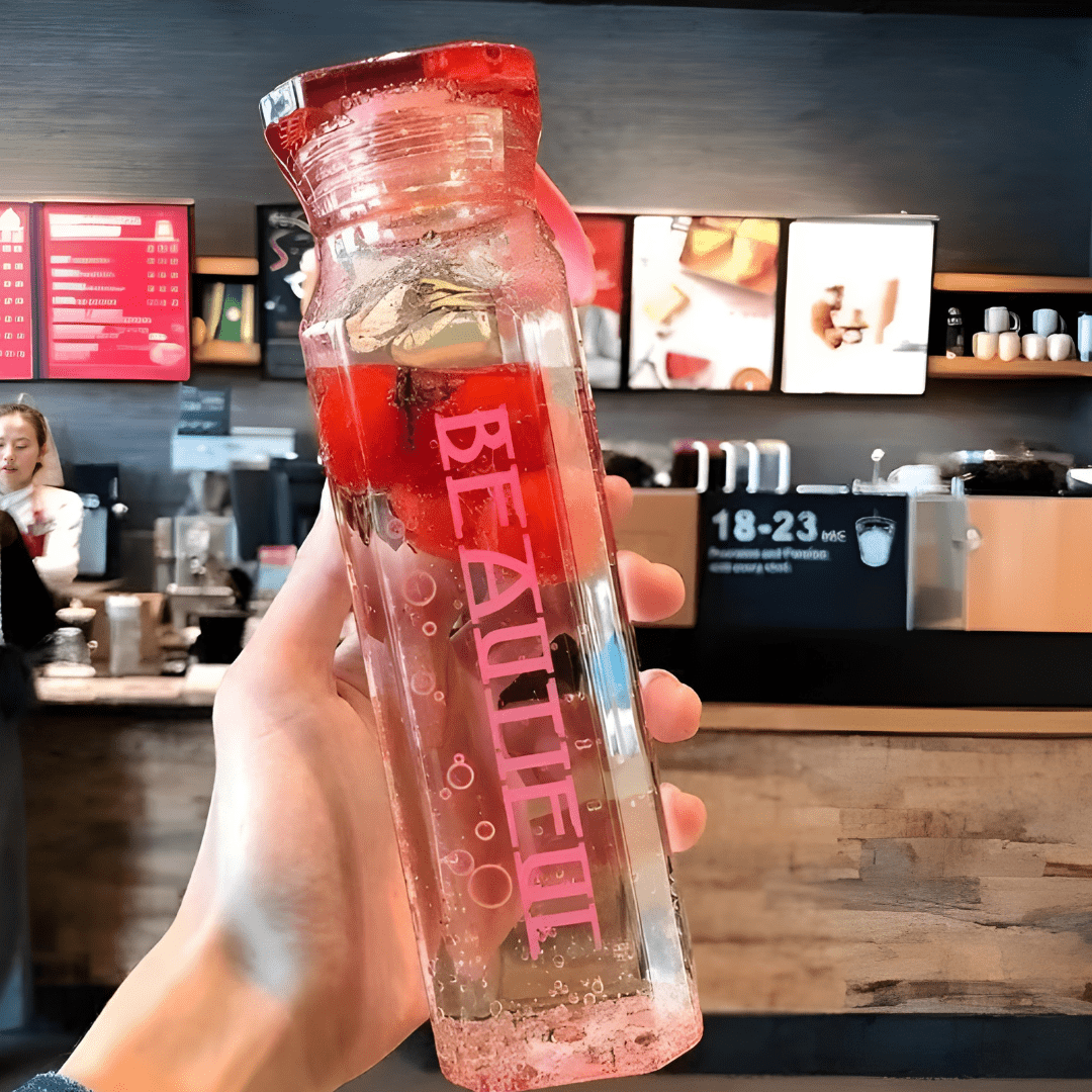 Diamond-shaped glass water bottle with fruit infusion, 500ml, available in amber, aqua, and ruby pink – eco-friendly with strap.