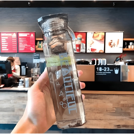 Diamond-shaped glass water bottle with fruit infusion, 500ml, available in amber, aqua, and ruby pink – eco-friendly with strap.