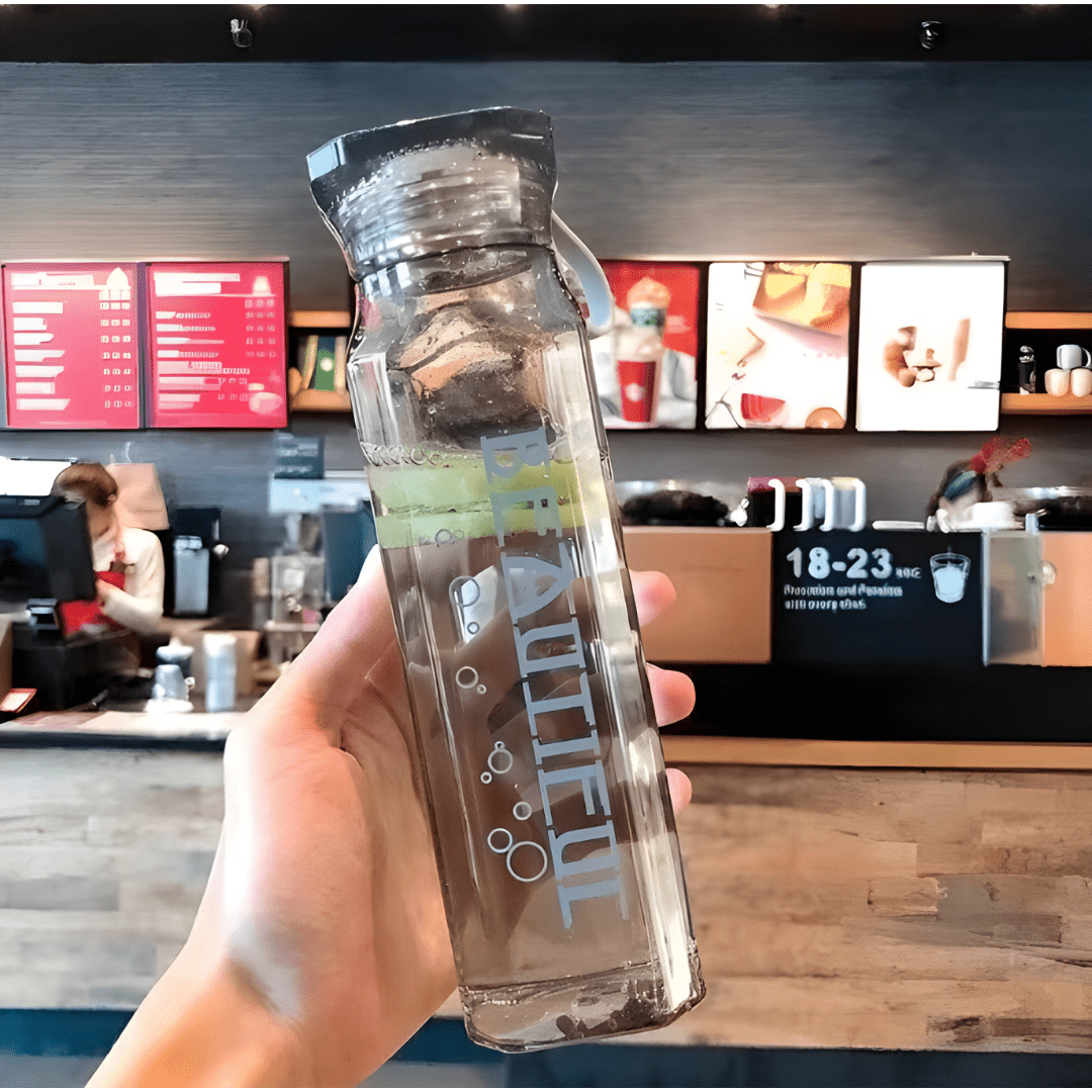 Diamond-shaped glass water bottle with fruit infusion, 500ml, available in amber, aqua, and ruby pink – eco-friendly with strap.