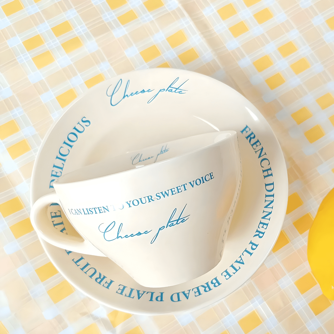 Ceramic mug with blue lettering and matching saucer