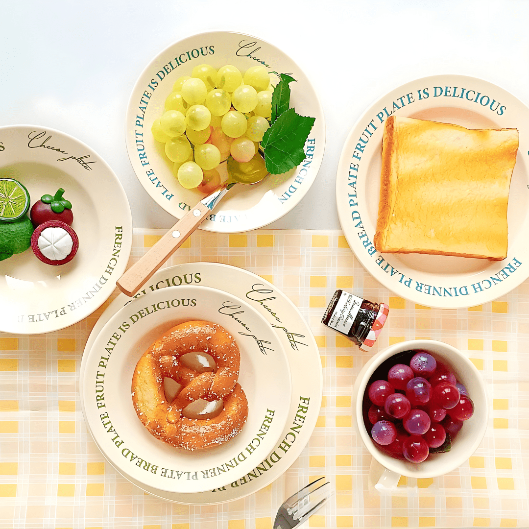 Assorted ceramic plates and cups with fruits and bread – stylish table setup