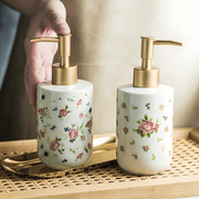 Retro white soap dispenser with golden pump and rose design – Beirut Lebanon