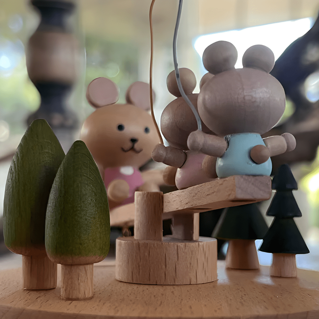 Wooden bunny family music box playing melody with moving seesaw
