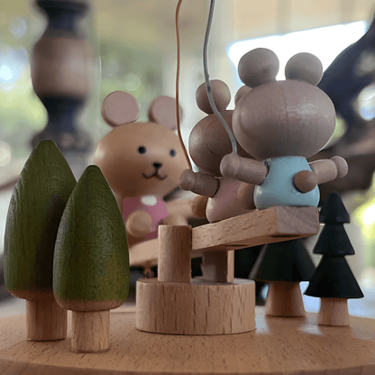 Wooden bunny family music box playing melody with moving seesaw