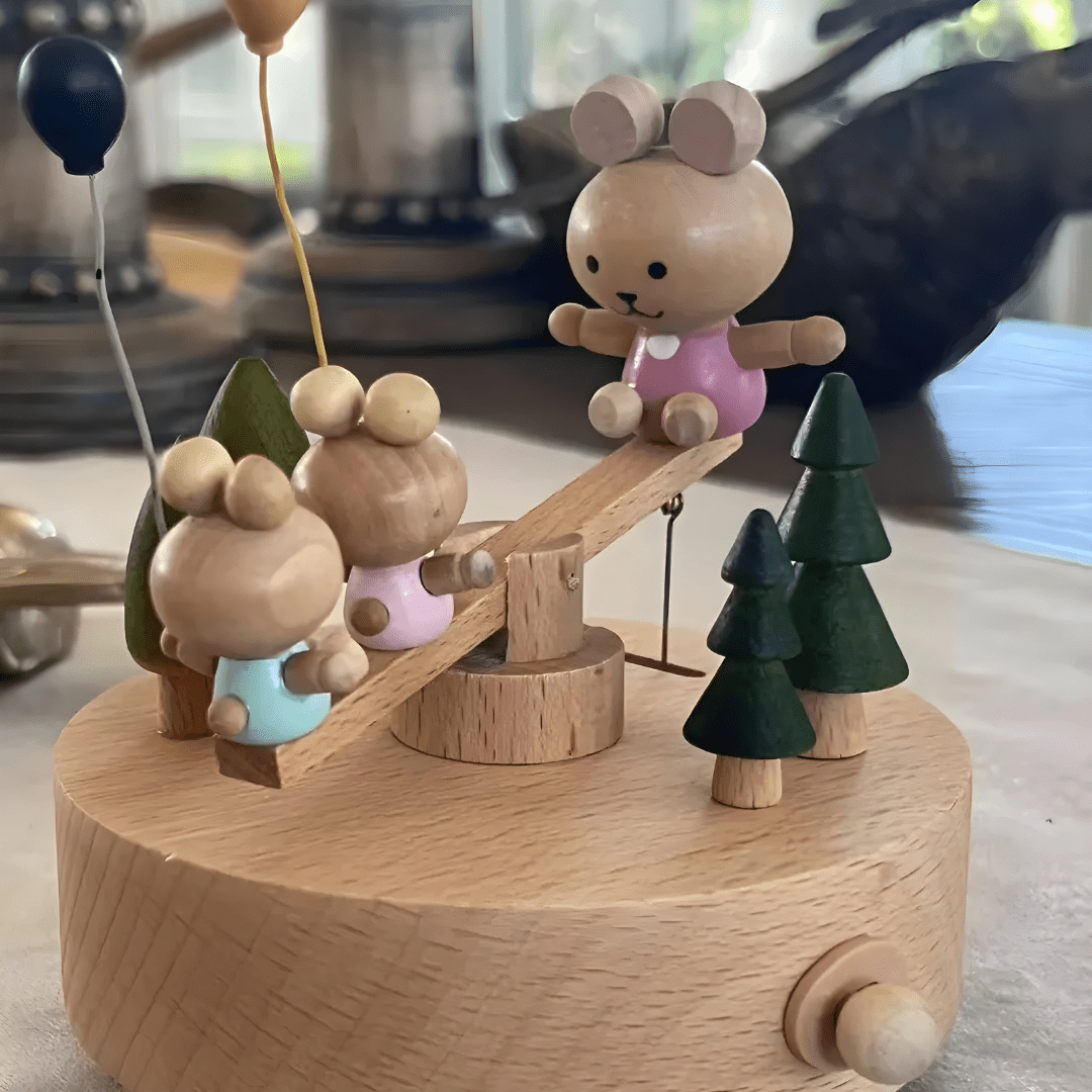 Wooden bunny family music box playing melody with moving seesaw
