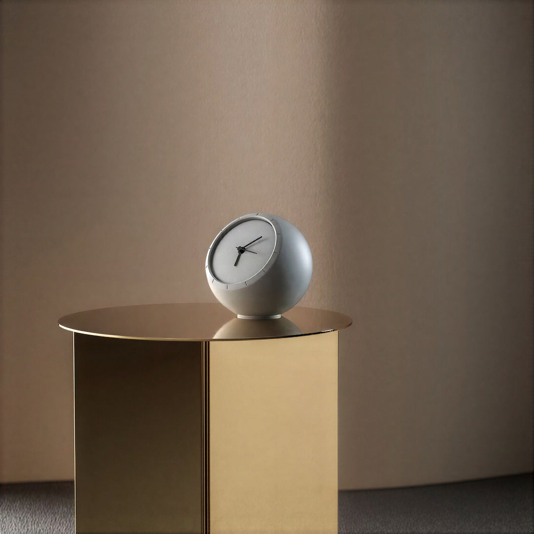 Modern grey concrete table clock displayed on a minimalist white side table