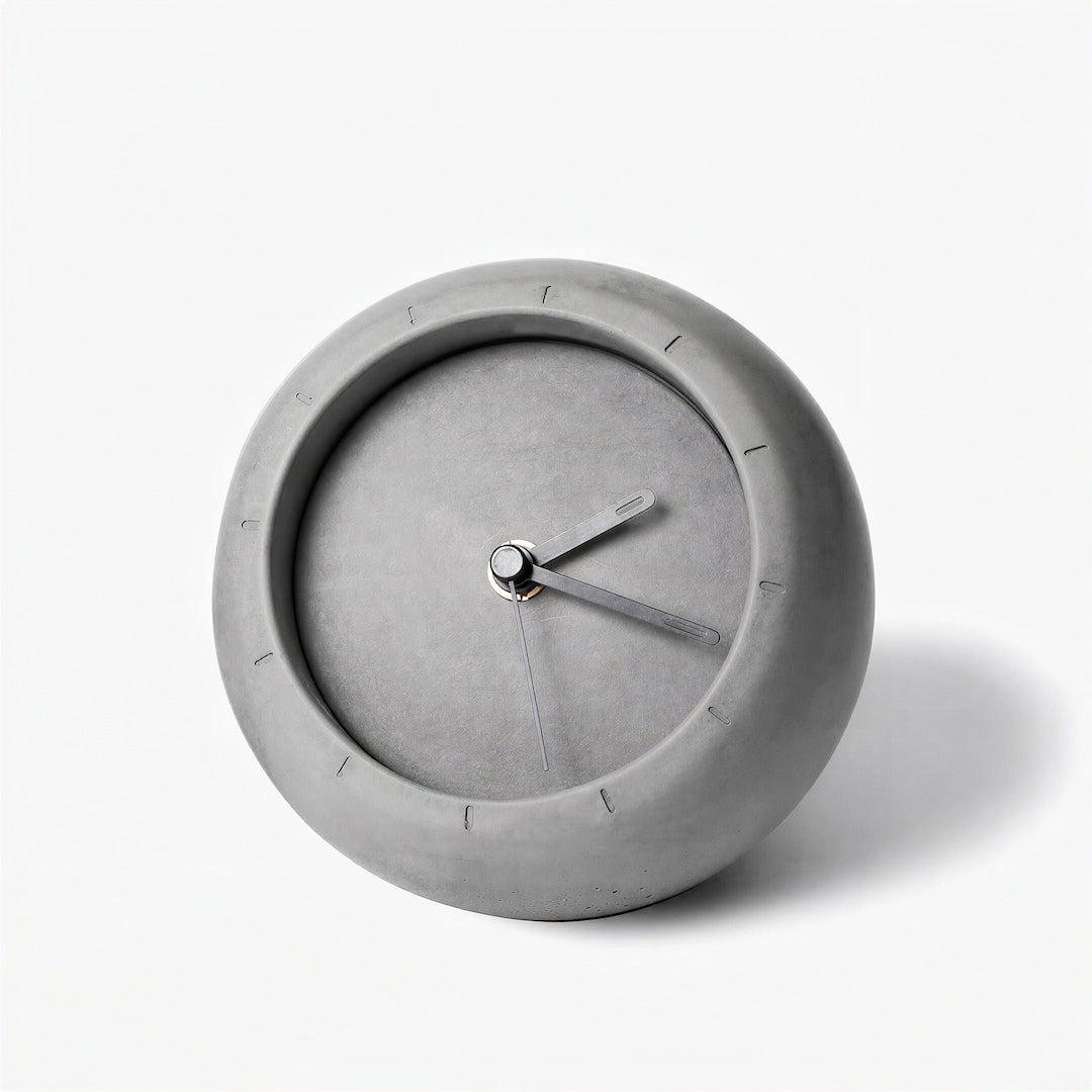 Modern grey concrete table clock displayed on a minimalist white side table