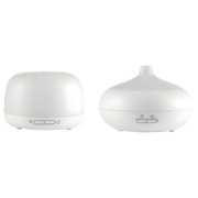 Silvercrest white ultrasonic aroma diffuser on a wooden table with cool mist rising, rechargeable Type-C aromatherapy device.