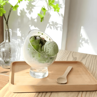 Clear tilted borosilicate glass dessert bowl with stand, 10.5×14cm – ideal for fruit salad, parfaits, and gourmet presentation.

