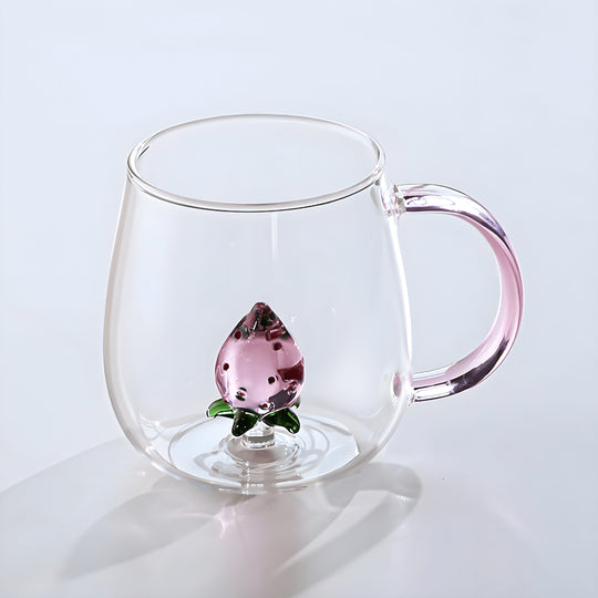 Clear borosilicate glass mug with pink 3D strawberry inside and ergonomic handle