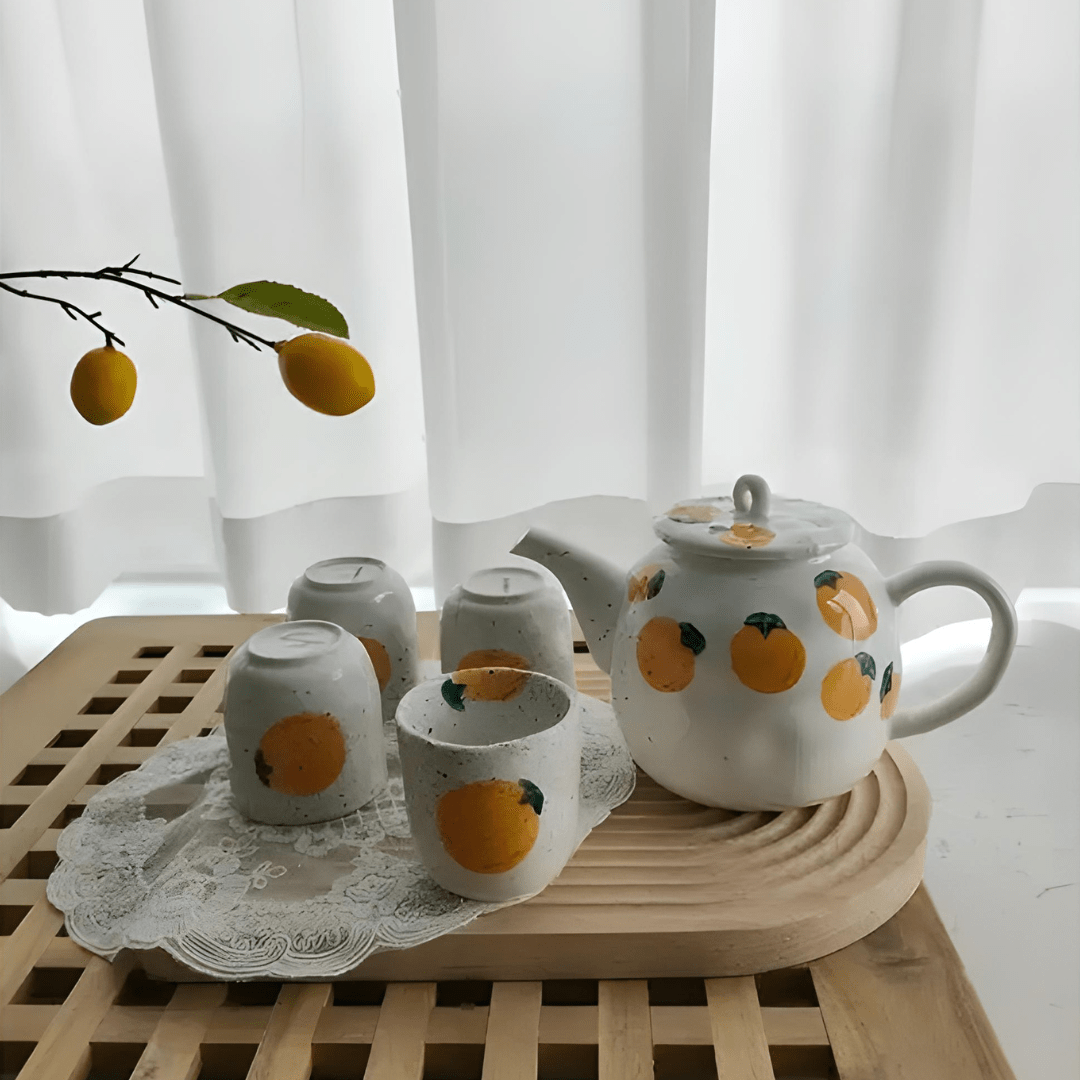 Porcelain citrus tea set with 850ml teapot and four 150ml cups – hand-painted orange pattern, perfect for summer tea moments in Beirut