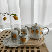 Porcelain citrus tea set with 850ml teapot and four 150ml cups – hand-painted orange pattern, perfect for summer tea moments in Beirut