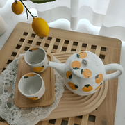 Porcelain citrus tea set with 850ml teapot and four 150ml cups – hand-painted orange pattern, perfect for summer tea moments in Beirut