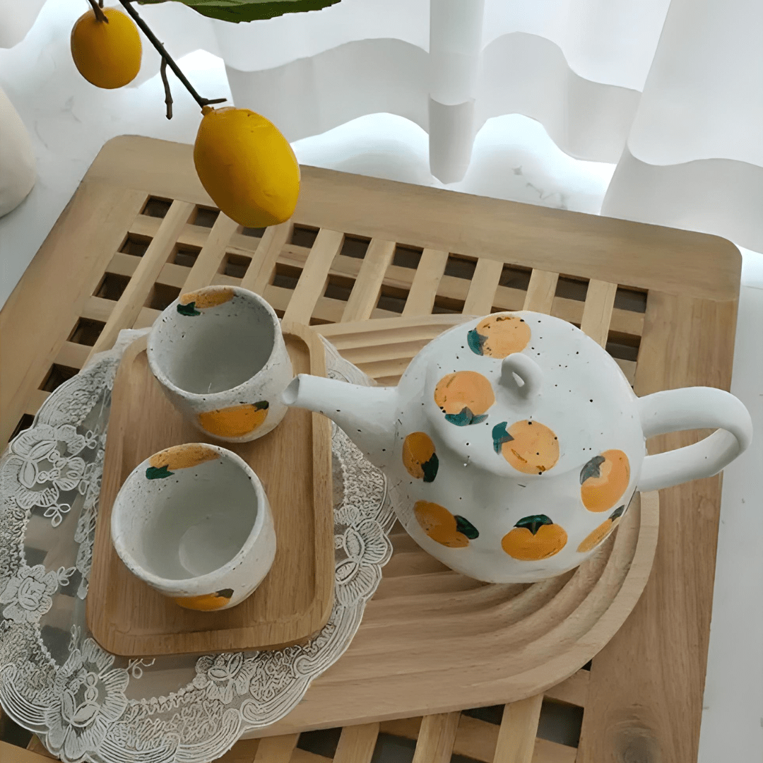 Porcelain citrus tea set with 850ml teapot and four 150ml cups – hand-painted orange pattern, perfect for summer tea moments in Beirut