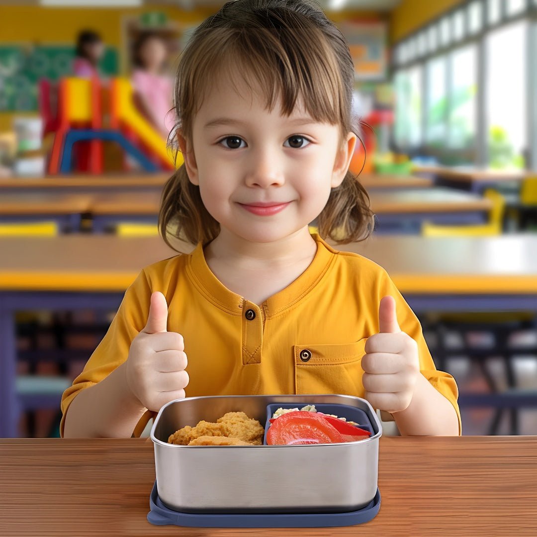 Happy child giving thumbs up while enjoying lunch from a stainless steel lunchbox by European House Hold in a school setting